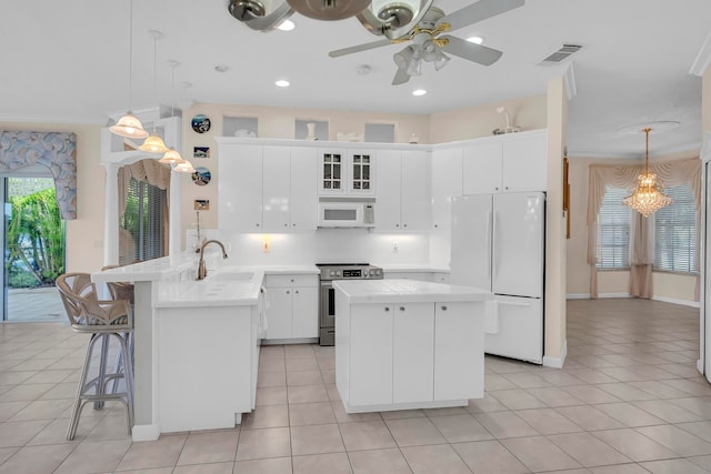 kitchen featuring ceiling fan with notable chandelier, white cabinetry, white appliances, and light tile patterned floors