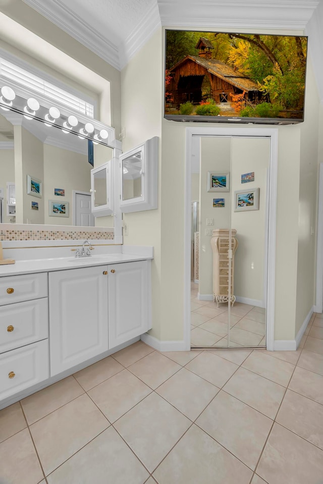 bathroom featuring tile patterned flooring, vanity, and ornamental molding