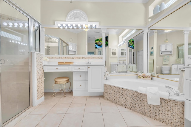 full bathroom with tile patterned flooring, vanity, independent shower and bath, and toilet