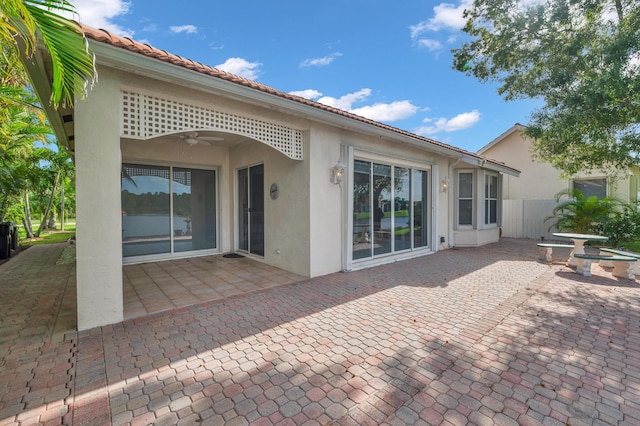 back of property with a patio and ceiling fan