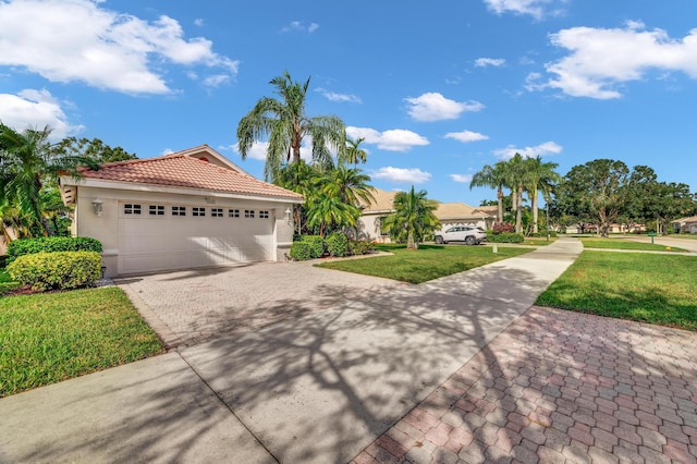 mediterranean / spanish house with a front lawn and a garage