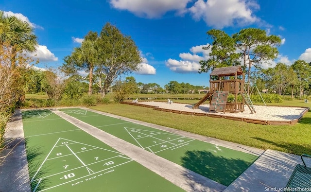 view of community featuring a playground and a lawn