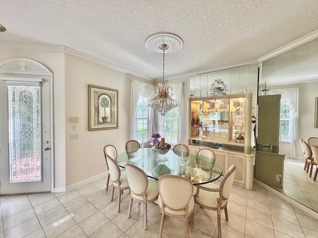 tiled dining room featuring crown molding, plenty of natural light, a textured ceiling, and an inviting chandelier