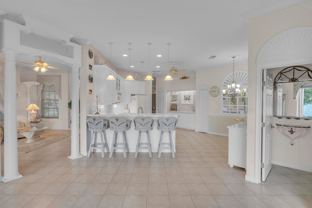 kitchen featuring white cabinets, ceiling fan with notable chandelier, light tile patterned floors, decorative light fixtures, and white fridge