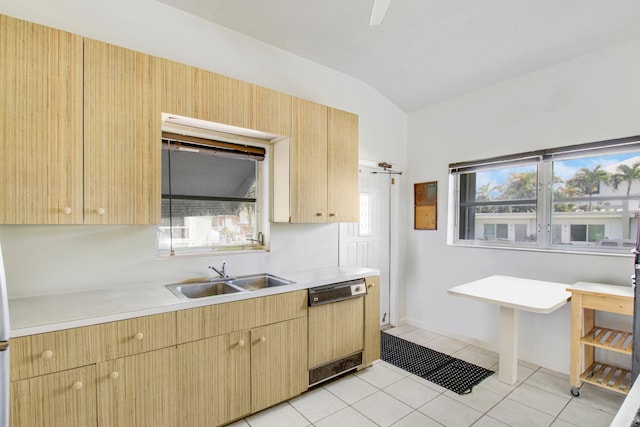 kitchen featuring light brown cabinetry, sink, light tile patterned floors, black dishwasher, and lofted ceiling