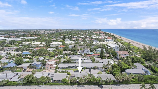 birds eye view of property with a water view and a view of the beach