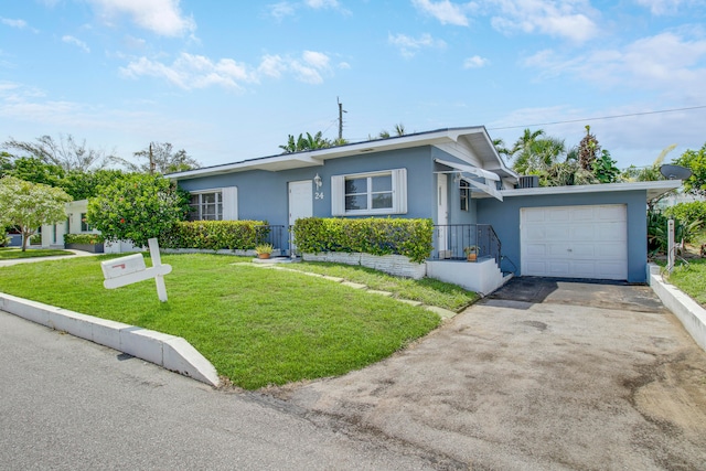 view of front of property featuring a garage and a front lawn