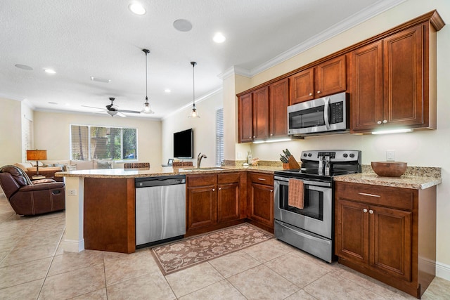 kitchen featuring stainless steel appliances, sink, kitchen peninsula, pendant lighting, and ceiling fan