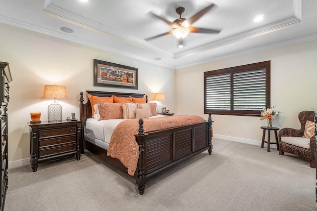 bedroom with ceiling fan, a tray ceiling, ornamental molding, carpet floors, and a textured ceiling