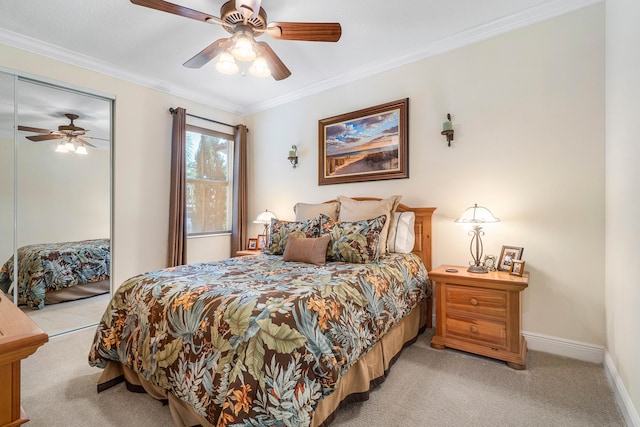 bedroom with a closet, carpet flooring, ceiling fan, and crown molding