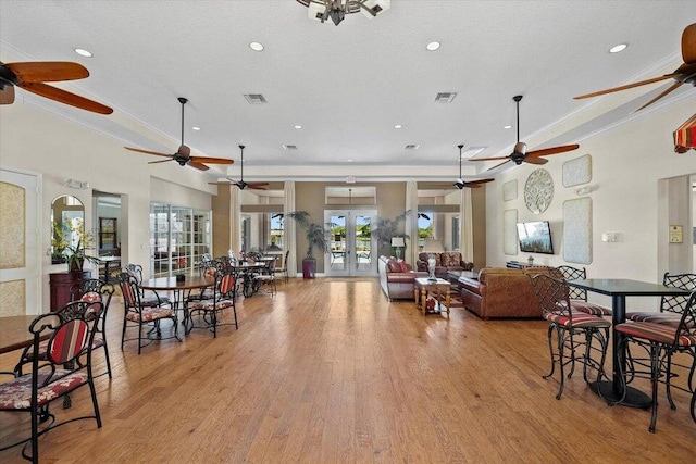 interior space featuring ceiling fan, french doors, and light hardwood / wood-style flooring