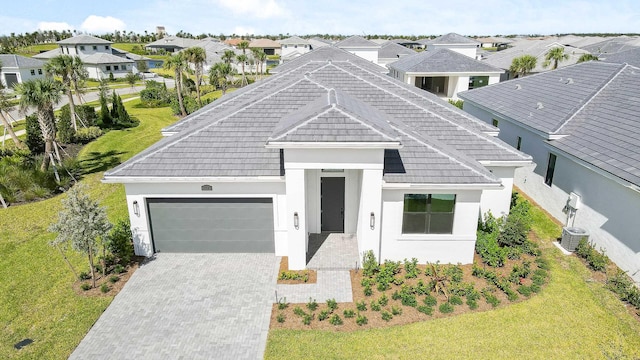 view of front facade with a front yard and a garage