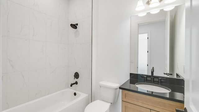 full bathroom with vanity, toilet, and tiled shower / bath combo