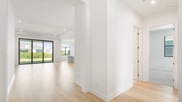 hall with light hardwood / wood-style floors