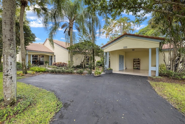 mediterranean / spanish-style home featuring a carport