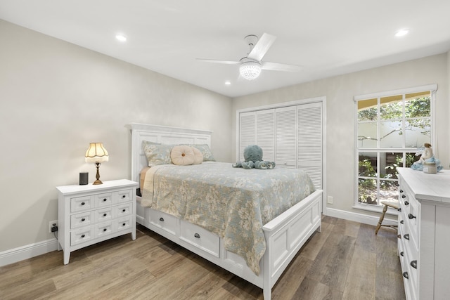 bedroom featuring a closet, ceiling fan, and light wood-type flooring