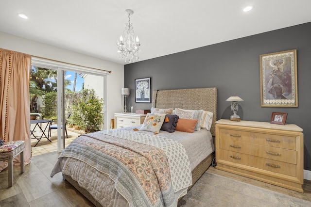 bedroom featuring an inviting chandelier and access to exterior