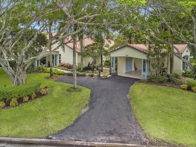 view of front of property featuring a carport and a front lawn