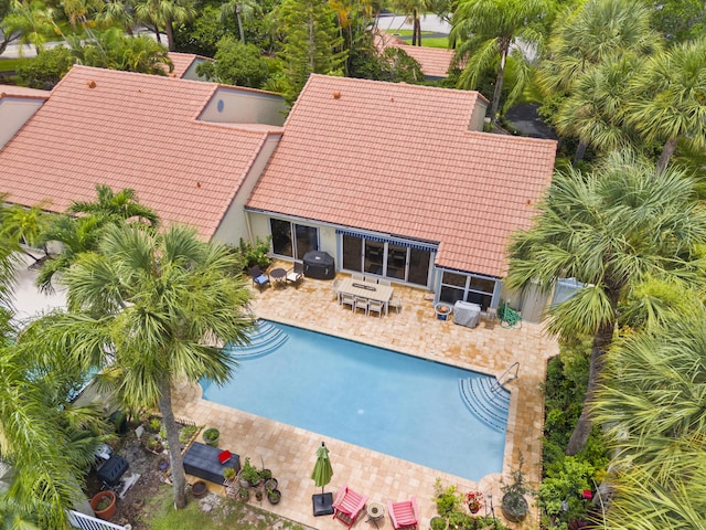 view of swimming pool featuring grilling area and a patio area