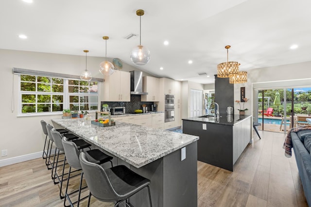 kitchen featuring white cabinetry, decorative light fixtures, and a spacious island