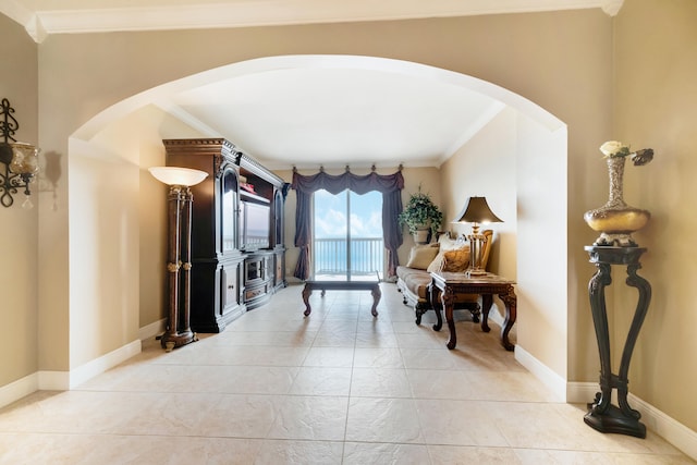 sitting room with light tile patterned floors and ornamental molding