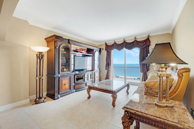 living room with ornamental molding and light tile patterned floors