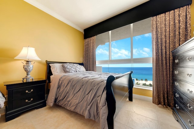 bedroom featuring crown molding, a water view, multiple windows, and light tile patterned floors