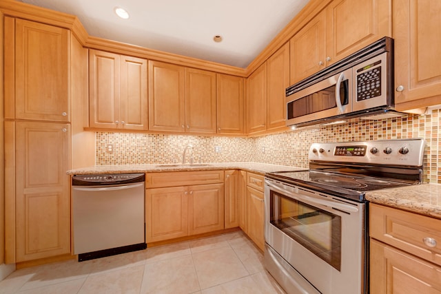 kitchen featuring stainless steel appliances, sink, light stone countertops, light tile patterned floors, and backsplash