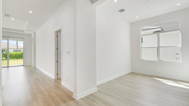 empty room with light hardwood / wood-style flooring