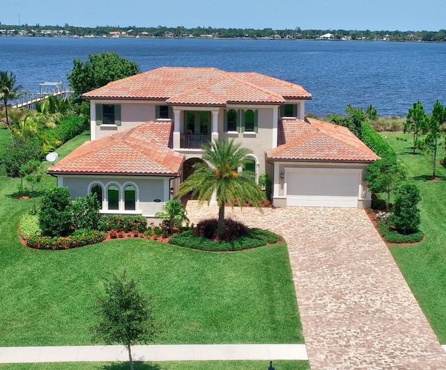 mediterranean / spanish home featuring a water view and a front yard