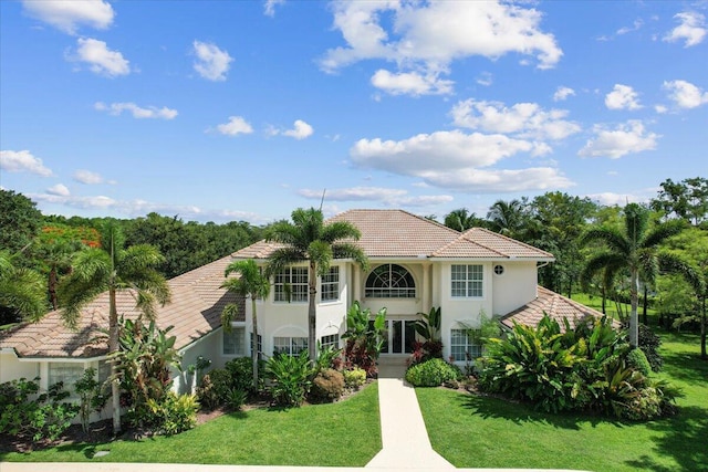 mediterranean / spanish-style home with a front lawn