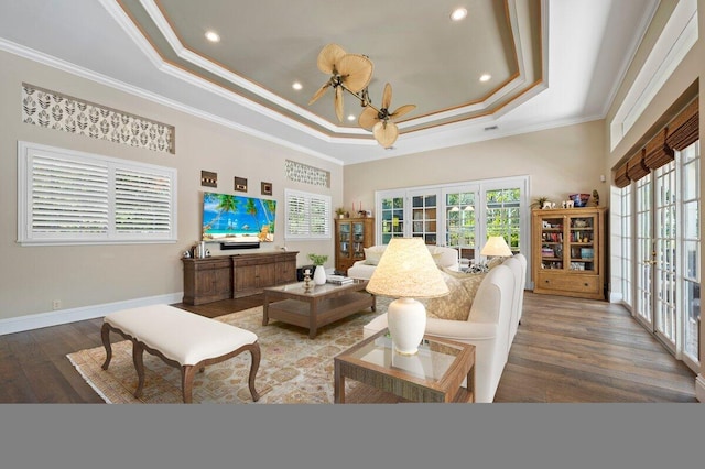 living room with french doors, a raised ceiling, ceiling fan, and ornamental molding