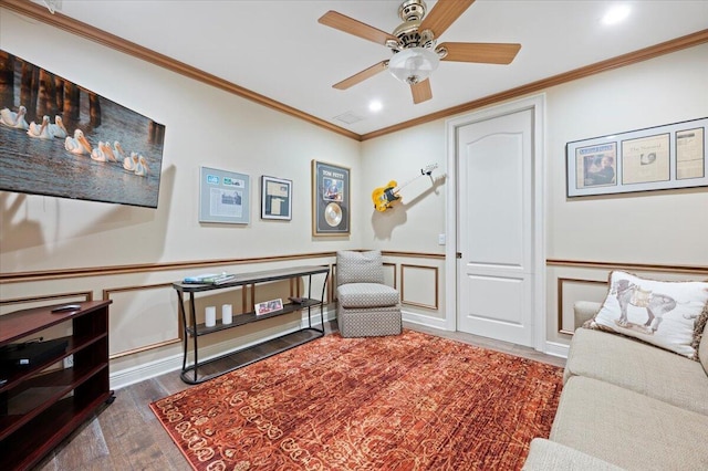 living room with crown molding, ceiling fan, and dark wood-type flooring