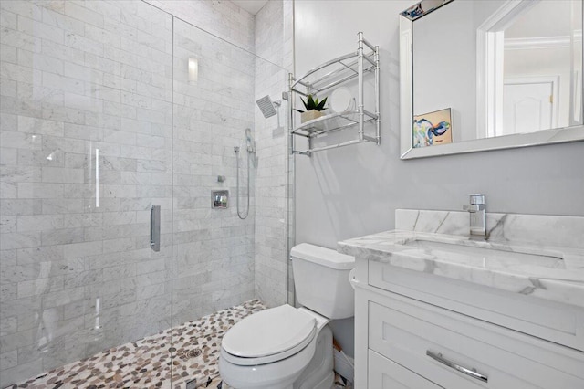 bathroom featuring vanity, toilet, and walk in shower