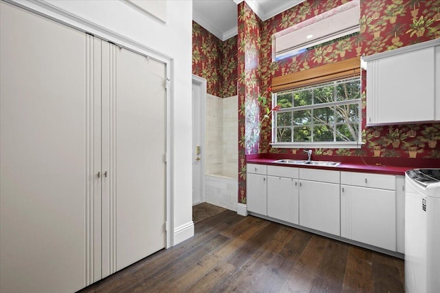 kitchen featuring white cabinetry, sink, dark hardwood / wood-style floors, and ornamental molding