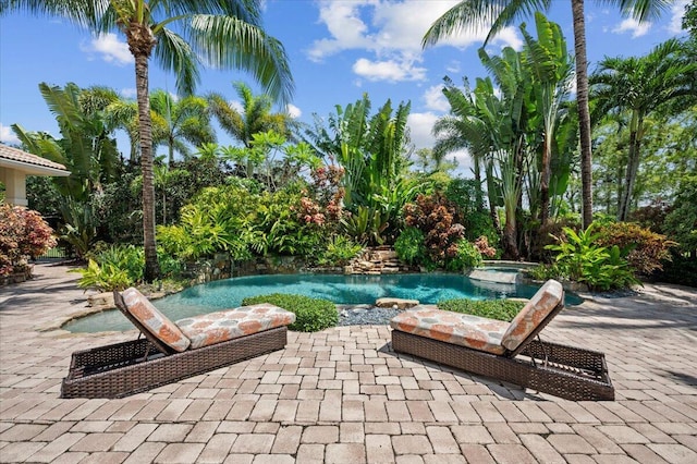 view of pool featuring an in ground hot tub and a patio area