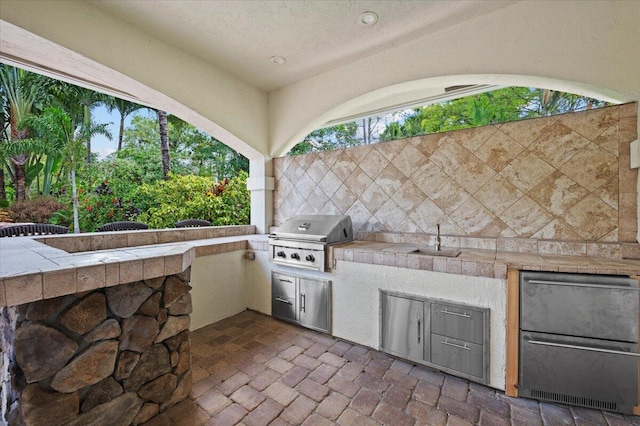 view of patio featuring sink, area for grilling, and exterior kitchen