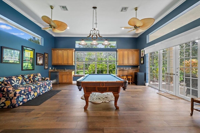 recreation room featuring hardwood / wood-style floors, ornamental molding, and pool table