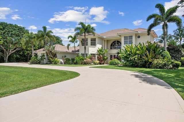 mediterranean / spanish house featuring a front yard