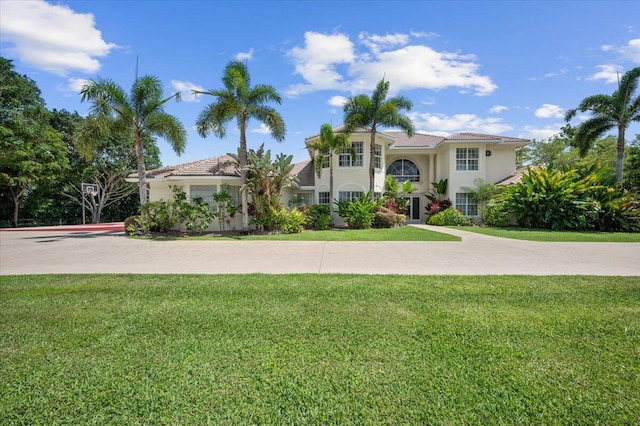 mediterranean / spanish home with a front yard