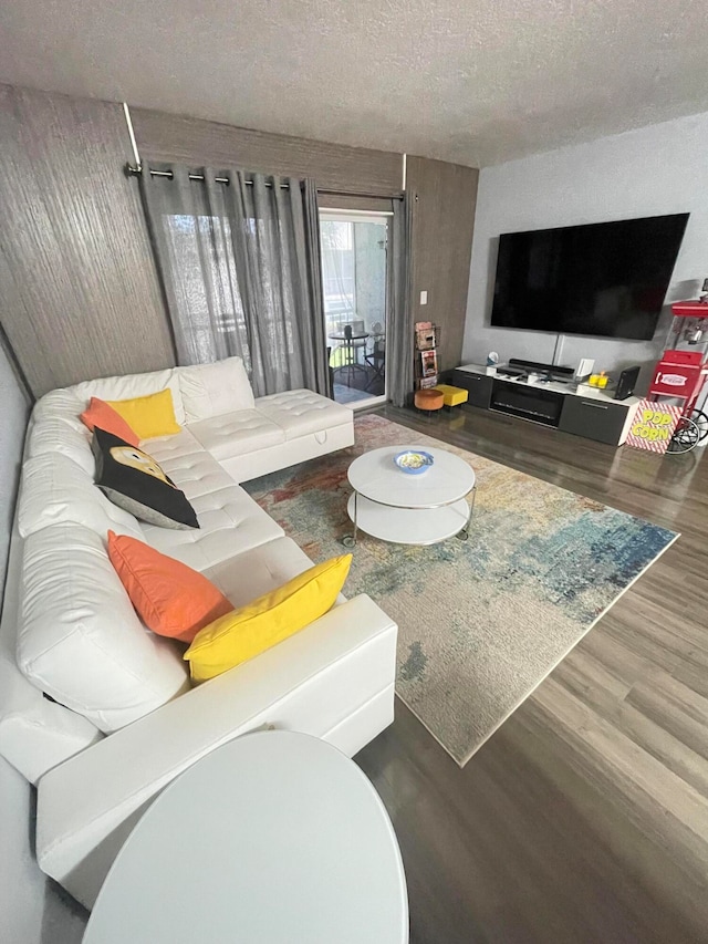 living room featuring a textured ceiling and hardwood / wood-style flooring