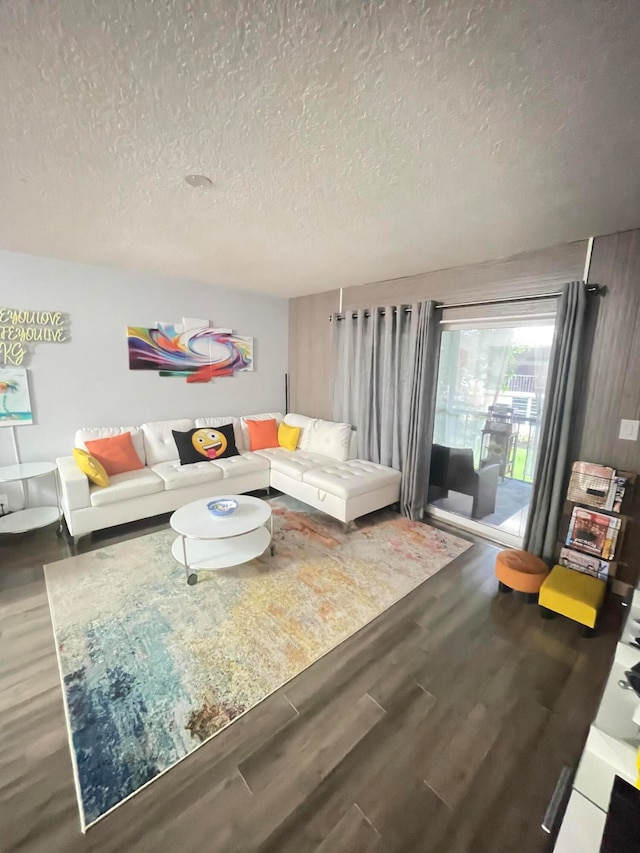 living room with hardwood / wood-style floors and a textured ceiling