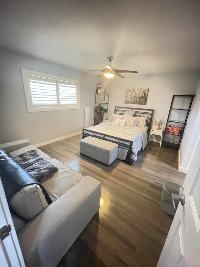 bedroom with ceiling fan and dark hardwood / wood-style flooring