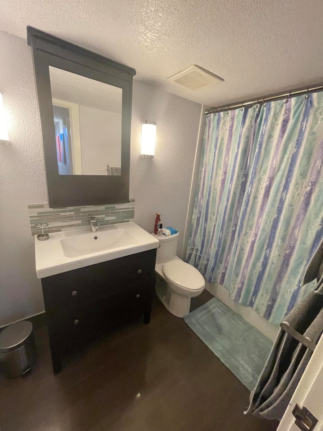 full bathroom featuring tasteful backsplash, shower / bath combination with curtain, a textured ceiling, toilet, and vanity