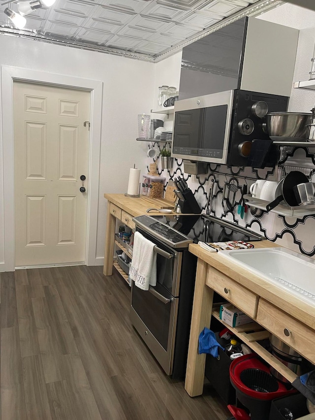 kitchen with butcher block countertops, dark wood-type flooring, and double oven range