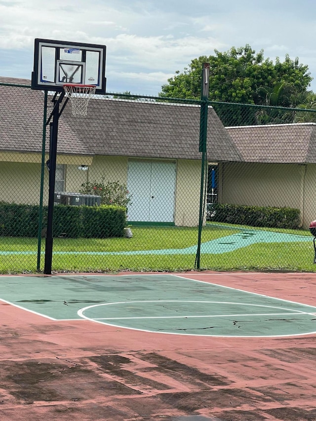 view of basketball court featuring a yard