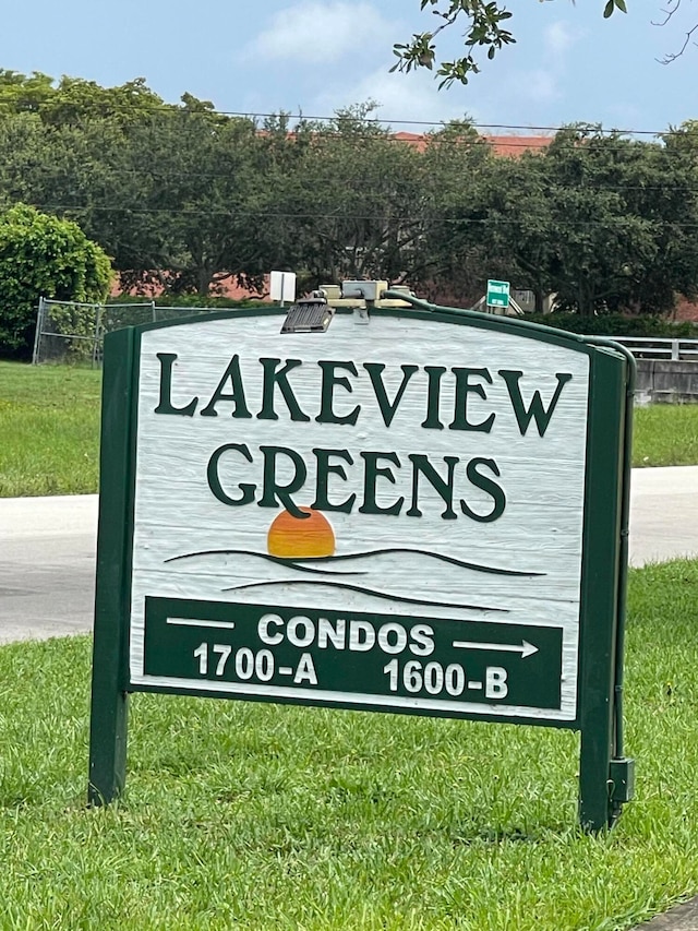 community sign featuring a lawn