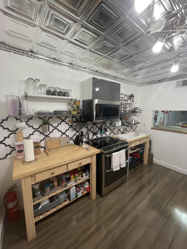 kitchen featuring dark hardwood / wood-style floors and appliances with stainless steel finishes