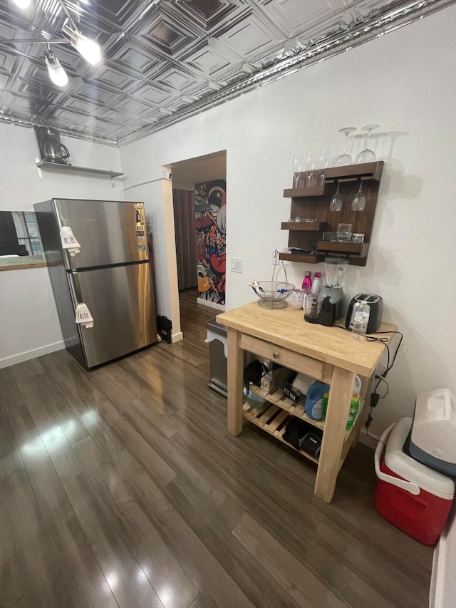 kitchen featuring stainless steel fridge and dark hardwood / wood-style floors