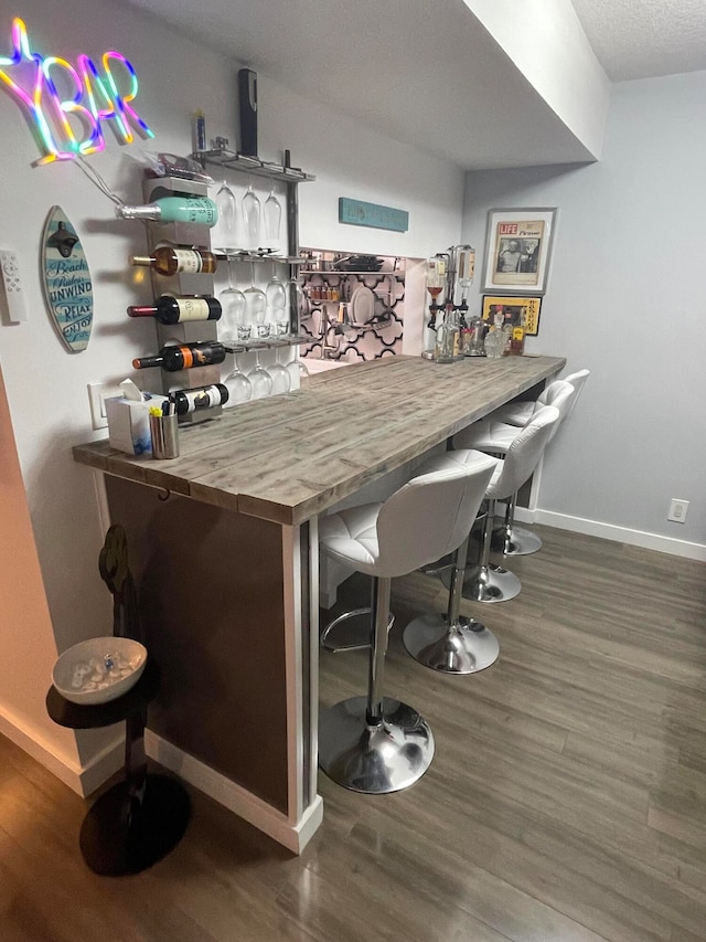 bar featuring dark hardwood / wood-style flooring